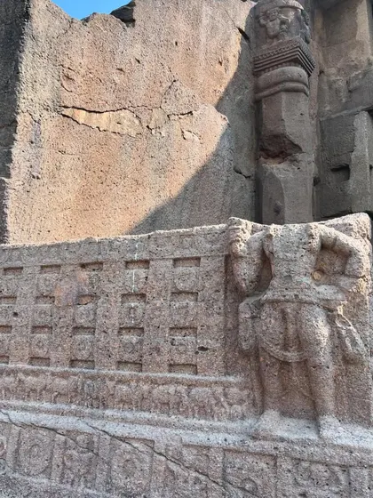 A weathered carving on an outer wall of the Kanheri Caves, showing the effects of time on this ancient Buddhist site.