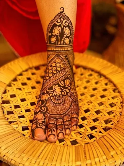 A single foot design with a lotus motif on the ankle and floral patterns on the foot. The clean lines and sharp details are my signature.