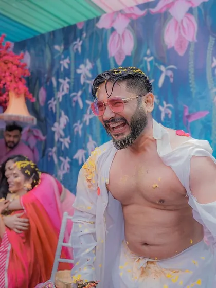 The groom's unrestrained laughter and joy during his Haldi, a perfect example of the candid, high-energy moments we love to capture.