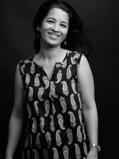 A bright and cheerful smile captured in a classic black and white portrait.