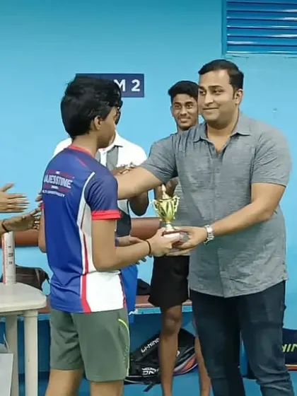Celebrating every achievement, big or small. A player receives a trophy at our internal tournament, a proud moment recognizing their hard work and sportsmanship.