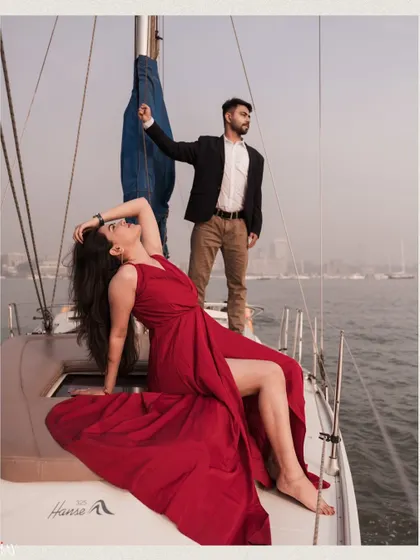 A high-fashion pose on the yacht, showcasing the couple's style and the luxurious feel of the shoot.