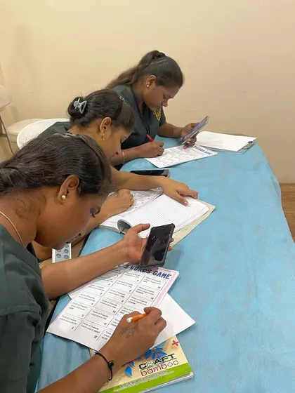 Participants using worksheets to practice their vocabulary and communication skills. These practical tools are designed specifically for the challenges faced in a healthcare service environment.