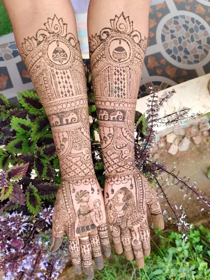The full view of the bridal mehendi, extending up to the elbows. The design includes elephants, kalash symbols, and detailed finger work, all done with my homemade organic henna.