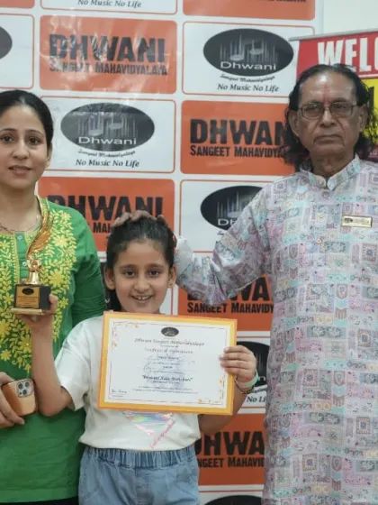 A student with her mother and guru, a picture of community and support.