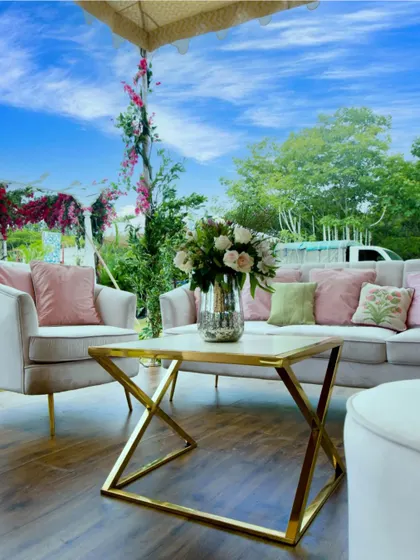 An outdoor lounge seating area with elegant furniture, perfect for a daytime event.
