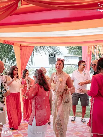 Guests enjoying the unique "Party Bus" photo booth at Nahdia and Varun's Mehendi in Kumarakom. We love adding these fun, interactive elements that reflect the couple's playful personality.