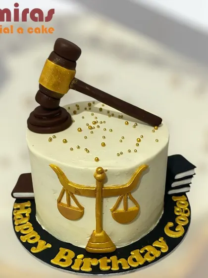 A cake that's in order for a lawyer. This design features a judge's gavel, the scales of justice, and law books, making it the perfect verdict for a legal professional's birthday.