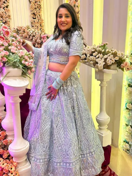This client looks absolutely obsessed with her look, and I am too. She is wearing a beautiful powder blue lehenga with intricate silver work, perfect for a day wedding or reception.