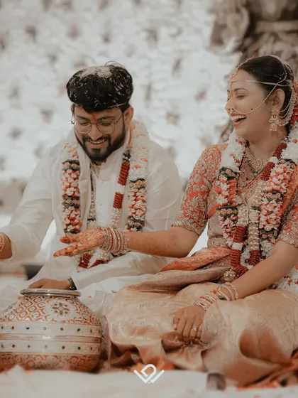 A happy couple portrait during their wedding rituals, capturing their shared laughter and the festive atmosphere of the day.