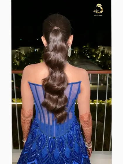 A closer look at the texture and flow of this wavy ponytail. I ensure every section is perfectly curled and set to create a seamless, cascading effect.