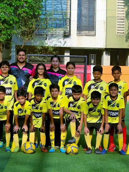 A group photo of our intermediate players and their coaches, showcasing the growth and progress at FANM.