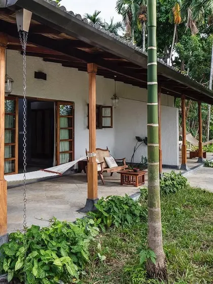 The long, shaded veranda that runs along the Garden Suites at Jalakara, connecting the rooms to the landscape.