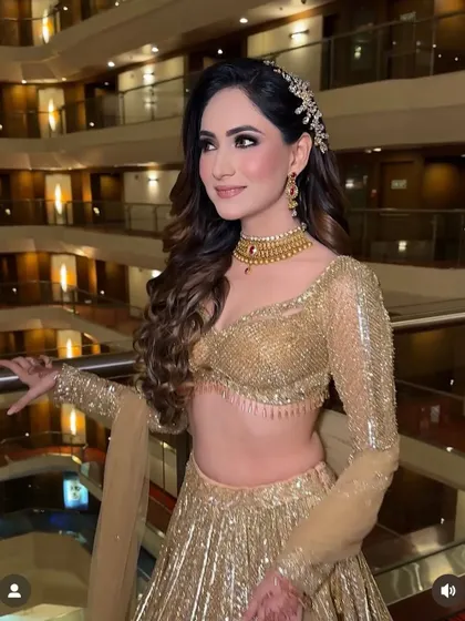 A touch of glamour with intricate curls and a sparkling hair accessory for an unforgettable engagement look.