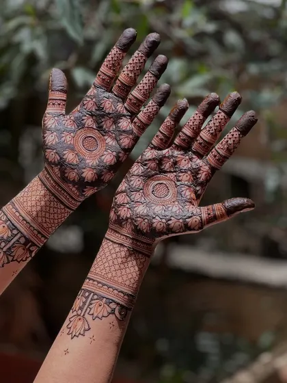 A clear shot of the lotus mandala design, showing the rich, dark color of the natural henna paste. The symmetry and clean lines are a hallmark of my work.