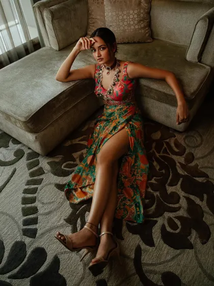 A full-length view of Shanvi Srivastava's brocade co-ord set. The thigh-high slit and draped skirt add a modern touch to the traditional fabric, making it a perfect fusion look.