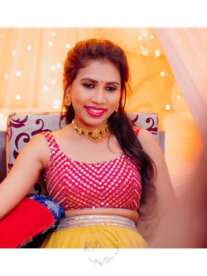 A close-up of our bride Varsha during her Mehendi ceremony, showing the vibrant pink sequined crop top I designed for her.