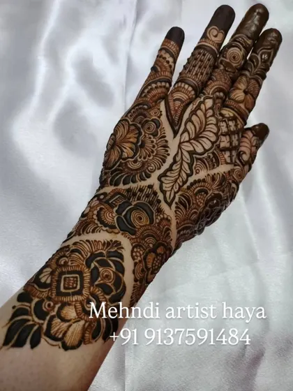 A striking design that uses a mix of bold, dark elements and delicate line work. The contrast creates a dynamic and eye-catching piece of bridal art.