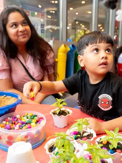A quiet moment of creativity during a high-energy Spiderman party. Here, a young guest gets hands-on with a planting activity, showing the blend of action and creativity I offer.
