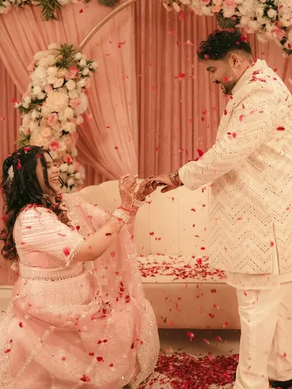 A playful moment during the engagement, with the bride getting down on one knee.