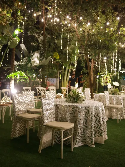 The perfect setting for a pre-wedding cocktail party or sangeet night. The lawn provides ample space for a dance floor, while the surrounding trees, lit with elegant chandeliers and string lights, create a festive and celebratory atmosphere.