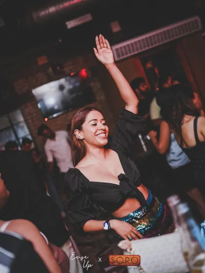 Another guest raising her hand, feeling the beat during our party in Goa.
