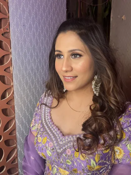 A portrait showing the complete look, with soft waves and a radiant, glowing complexion.