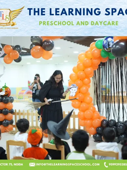 A teacher dressed as a witch leads a puppet show for an enchanted audience. Storytelling and performance are key elements of our magical events.