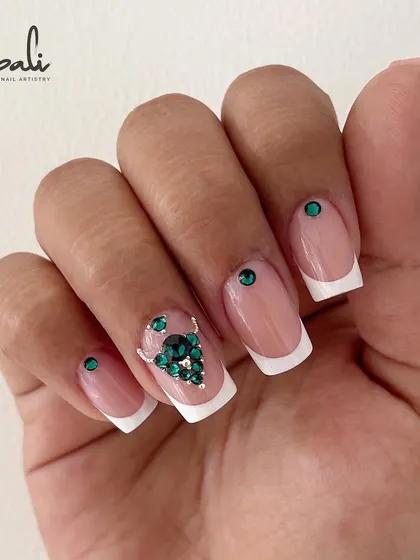 A full set of square French tip extensions with a beautiful green Swarovski crystal design. This is one of my older works, but it remains a favorite.
