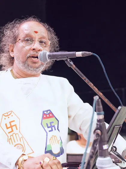 A musician delivers a devotional performance at the JITO Navkar Mantra Divas. We provide complete audio-visual support to ensure every performance is heard and seen clearly.
