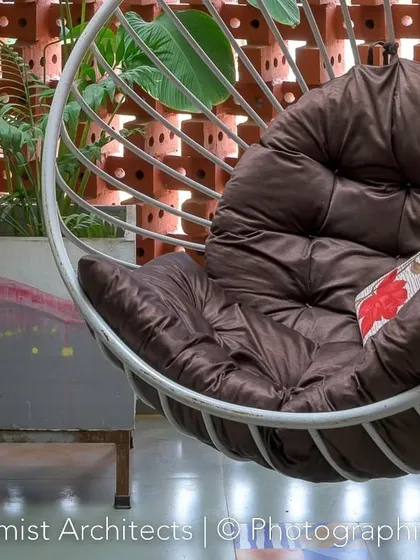 The cushioned swing chair offers a comfortable spot to enjoy the semi-outdoor balcony space.