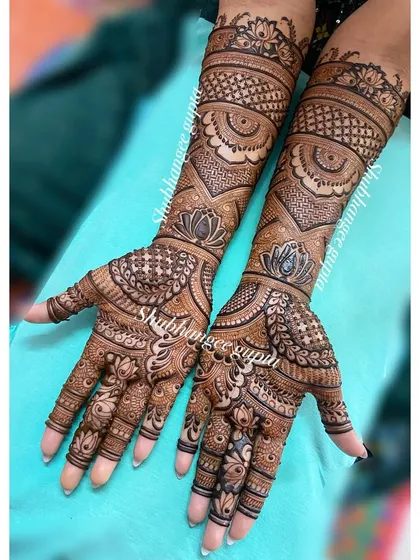 Another angle of this beautiful engagement mehndi, showing how the patterns flow seamlessly from the palm to the arm. The design is dense yet clear and elegant.