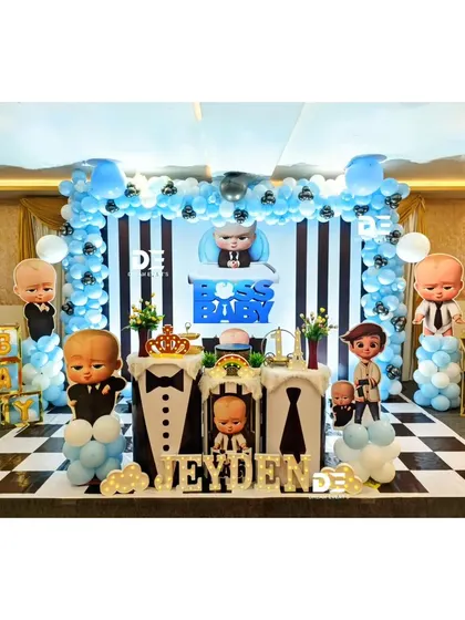 Who's the boss? Jeyden is! This Boss Baby first birthday party features a stylish black, white, and blue color scheme, with a checkered floor, character cutouts, and tuxedo-themed pedestals.