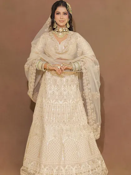 A full-length view of the pearl white lehenga, showcasing its intricate all-over embroidery and elegant silhouette.