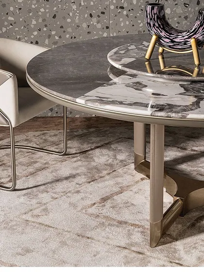 A piece of advice for dining tables: always opt for a marble top for durability and timeless elegance. This custom table features a dual-toned marble top and a sculptural metal base, showcasing our expertise in bespoke furniture.
