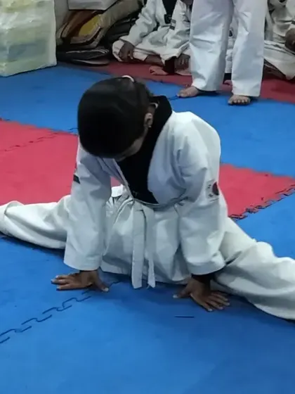 Flexibility is a cornerstone of Taekwondo. We guide our students, even the youngest ones, to safely develop incredible flexibility, like achieving a full split, which is crucial for advanced kicks.