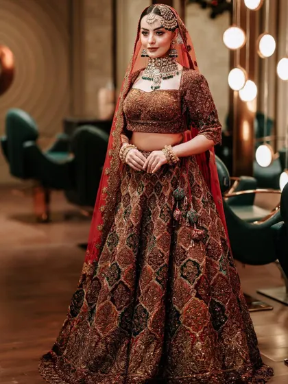 The bride looking confident and beautiful in her complete bridal ensemble.