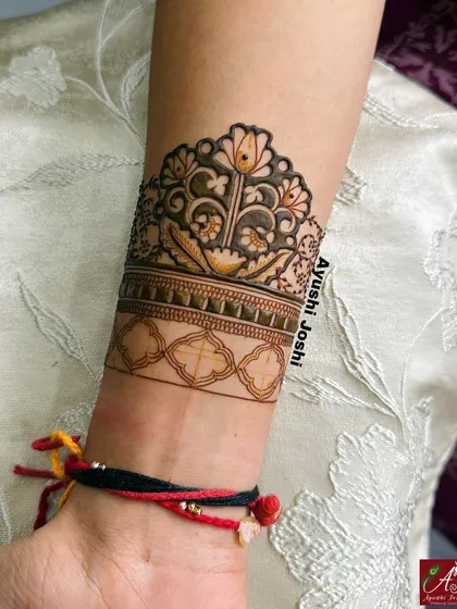The floral arm band in progress, with the main flower filled in and the lower band outlined.