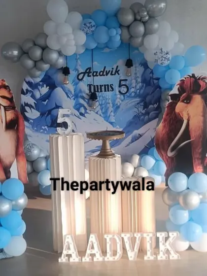 An Ice Age theme for a 5th birthday, featuring cutouts of Manny and Diego against a snowy backdrop.