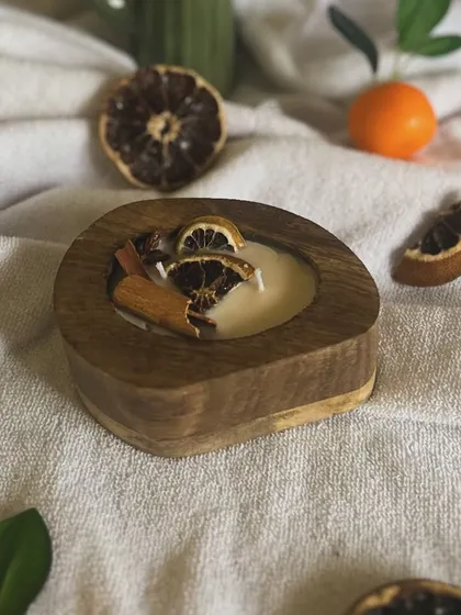 My autumn special scented candle, featuring dried orange slices and cinnamon sticks in a rustic wooden bowl.