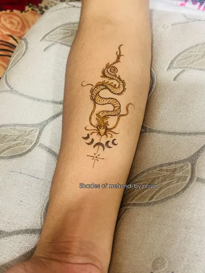 A close-up of the dragon tattoo, showing the fine lines and details.