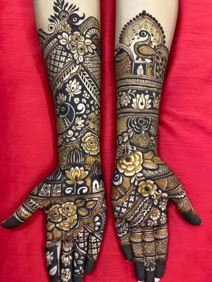 A stunning combination of peacock, floral, and lotus motifs, covering the arms from elbow to fingertips.