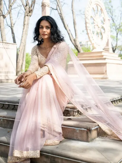 Like a gentle breeze on a cool morning. This pale peach pre-stitched saree is refreshing and elegant.