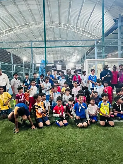 A large group photo of all the participants and winners from the football tournament on our turf.