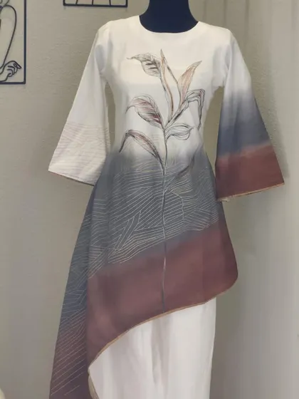 I love the hand-painted look of this asymmetrical tunic and pant set. The ombre effect from white to grey and brown, combined with the delicate botanical print, makes this a truly unique fusion piece.