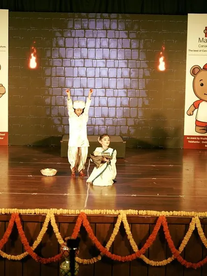 A dramatic scene from the Maple Bear annual day, where I incorporated simple but effective props and stage lighting to enhance the storytelling. The stage is decorated with traditional marigold garlands for a festive touch.