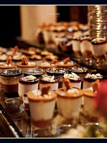 A beautiful display of my shot-glass desserts, featuring different layers and toppings. This presentation style is modern, elegant, and very popular at events.