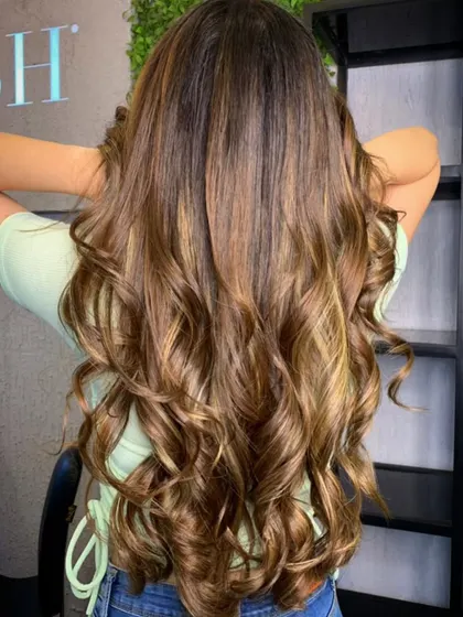The stunning result of a golden brown balayage. We took our client's natural dark hair and added beautiful, warm highlights for a complete hair transformation.