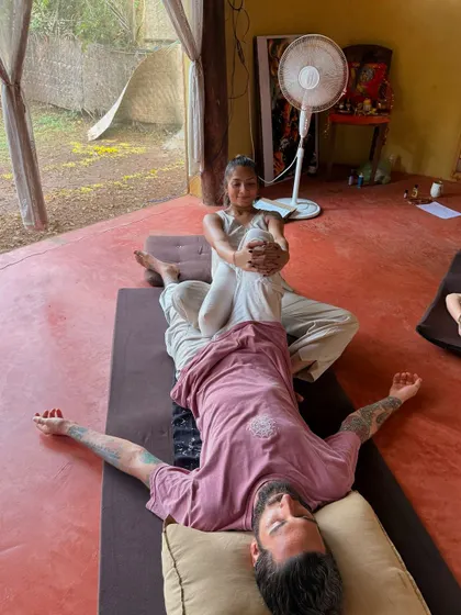Working on the hamstrings and hips in a supine position. This kind of assisted stretching allows for a deeper release than one can often achieve alone.