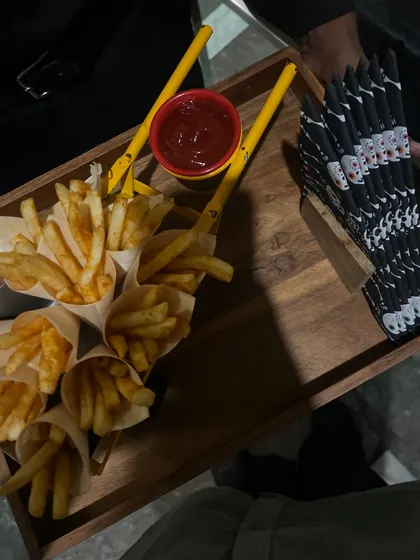 Cones of french fries with ketchup, served on a wooden tray with spooky napkins. Sometimes the simplest things are the most popular at a party.